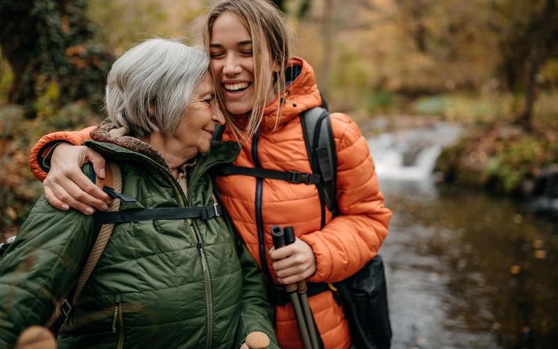 a couple of women smiling while hiking