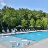 Resort-style pool with lounge chairs at The Hominy apartments in Candler, NC.
